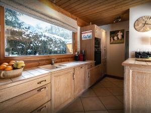 a kitchen with a sink and a window at Chalet J'Elage - OVO Network in Saint-Jean-de-Sixt +29 photos