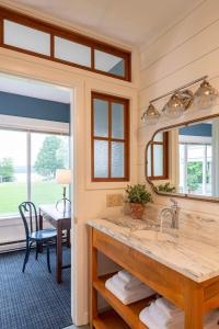 a bathroom with a sink and a mirror at Basin Harbor in Vergennes