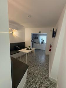 a small room with a table and a kitchen at Cool Guest House in Elvas +24 photos