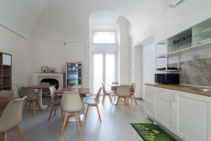 a kitchen with chairs and a dining room with a table at Palazzo Vesuviano in Terzigno
