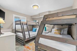 two bunk beds in a room with a desk at SunDestin Resort Unit 1018 in Destin