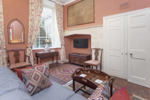 a living room with a couch and a tv at 1 Bed in Bath oc-bhr34 in Bath