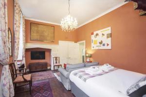 a bedroom with a bed and a couch and a television at 1 Bed in Bath oc-bhr34 in Bath