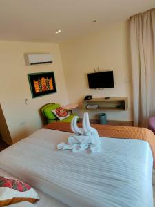 a hotel room with a bed with towels on it at Nubian Hotel in Cairo