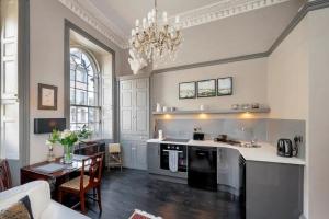 a kitchen with a stove and a table in a room at 1 Bed in Bath oc-bhr33 in Bath