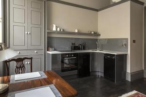a kitchen with black appliances and a wooden table at 1 Bed in Bath oc-bhr33 in Bath +9 photos