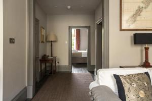 a living room with a couch and a bedroom at 1 Bed in Bath oc-bhr33 in Bath