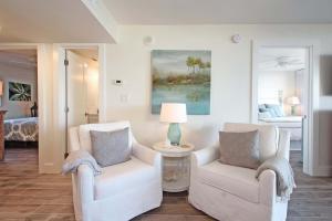a living room with two chairs and a bed at One Seagrove Place 0205 in Santa Rosa Beach +41 photos