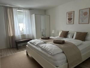 a large white bed in a bedroom with a window at Apartment Lale - Frankenwald, Waldblick & Rennsteig in Steinbach am Wald +12 photos