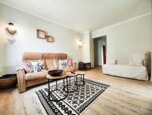 a living room with a couch and a table at Le repère des amis - 4 pers - proche tram - parking gratuit - babyfoot in Lingolsheim +21 photos