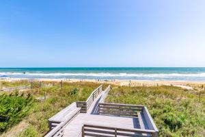a wooden path to the beach with the ocean in the background at T.L. Sea - KDH MP 6, Oceanfront, Ocean view, Rec Room, Spacious Decks, Private Walk to Beach in Kill Devil Hills