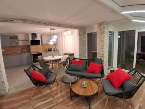 a living room with black chairs and red pillows at Apartment Andreja Bled in Bled