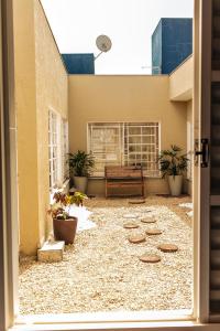 a courtyard with a bench on the side of a building at Niv's Hotel in Monte Sião