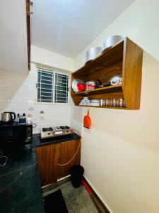 a kitchen with a counter and a counter top at Namma Suites 1BHK Serviced Apartment near NIMHANS & St Johns hospital in Bangalore