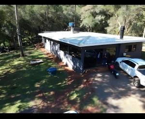 a house with a car parked in front of it at Recanto Rivière in Guarapuava