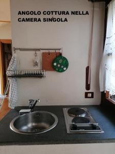 a kitchen counter with a sink and a stove at casaNARDIELLO in Capua