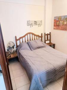 a bedroom with a bed with musical notes on the wall at Depto Avenida Colón-Mar del Plata in Mar del Plata