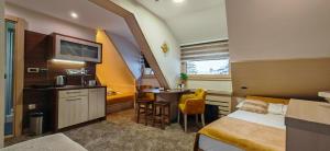 a hotel room with a bed and a small table at Angella KOP Konaci in Kopaonik