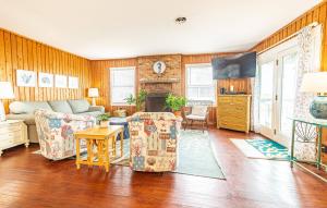 a living room with a couch and a table at Serendipity - KDH MP 6.5, Oceanfront, Amazing Ocean View, Hot Tub, Pets OK, YR Flex Stays in Kill Devil Hills
