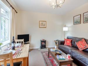 a living room with a couch and a table at Polly's Fold in Grassington