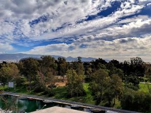 a view of a park with trees and a bridge at Carol Hotel in Piraeus