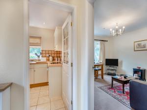 a kitchen and living room with a table and a dining room at Polly's Fold in Grassington