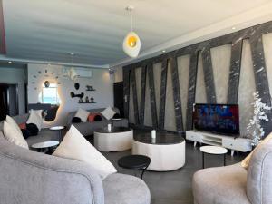 a living room with couches and a flat screen tv at شاليه درة العروس in Durat Alarous