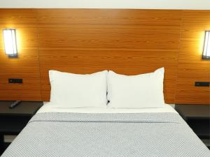 a bed with two white pillows in a room at SOFI MOTEL in Los Angeles