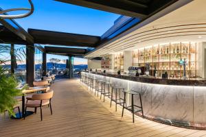 a restaurant with a bar with chairs and tables at The Stanley in Athens