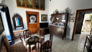 a living room with a table and chairs and a room at Camaraki Capitano House , Chora Serifos in Serifos Chora