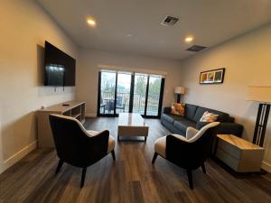 a living room with a couch and a table and chairs at Xquisite Suites in Freeport