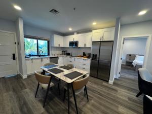 a kitchen with a table and chairs and a kitchen with a bed at Xquisite Suites in Freeport