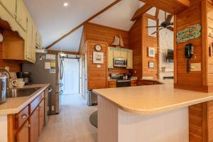 a kitchen with wooden cabinets and a counter top at Just For Fun - Duck, Schooner Ridge, Pool Open 4/15, Pool Heat Option, Hot Tub, Close to Downtown in Duck