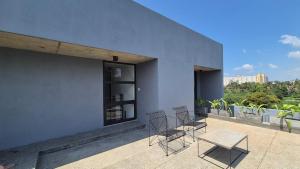 a group of chairs and a table on a building at Stillwater Edge 2 - Level Two in Sri Jayewardenepura Kotte
