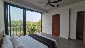 a bedroom with a bed and a ceiling fan at Stillwater Edge 2 - Level Two in Sri Jayewardenepura Kotte