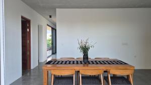 a dining room with a wooden table and chairs at Stillwater Edge 2 - Level Two in Sri Jayewardenepura Kotte
