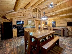 a kitchen with a wooden ceiling and a table at Roosevelt Hotel & Cabins - Yellowstone in Gardiner