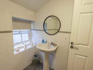 a bathroom with a sink and a mirror at 21 Entry Lane in Kendal +25 photos