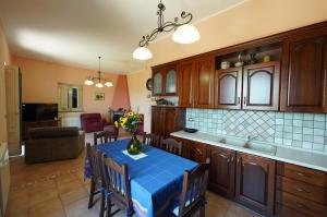 a kitchen with a table with a blue table cloth at Villino AL CASTAGNO in SantʼAlfio