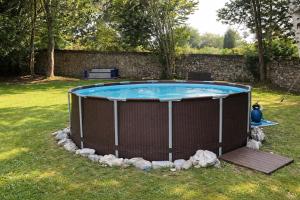 a large swimming pool in a yard with a fence at Llanes Villa con Piscina y Jardín – Las Ardillas in Cardoso