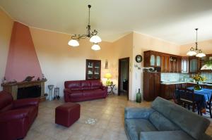 a living room with a couch and a table at Villino AL CASTAGNO in SantʼAlfio