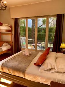 a large bed in a bedroom with a large window at BbCasita Blue-Hostal in Santiago