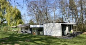 a small house in the middle of a field at Bungalow 140 in Maarkedal