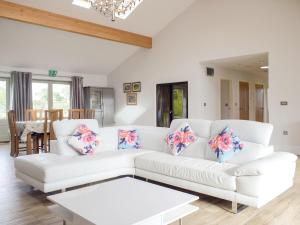 a living room with a white couch and a table at Lovells Barn in Welland