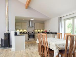a kitchen and dining room with a table and chairs at Lovells Barn in Welland