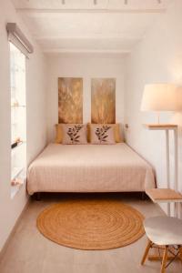 a bedroom with a large bed with a rug at Torre Costa Brava Private pool in Garrigás +25 photos