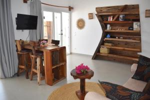 a living room with a table and a desk at Tremendo Beachfront Apartment in Kiwengwa