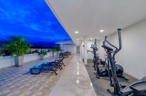 a fitness center with treadmills and exercise bikes at Hotel MS Ciudad Jardin Plus in Cali