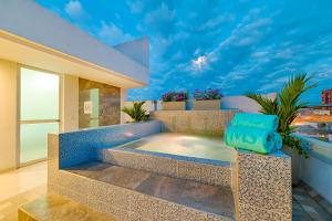 a villa with a plunge pool on a balcony at Hotel MS Ciudad Jardin Plus in Cali