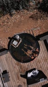 a round glass table on a wooden deck at Surf Lodge Punta de Lobos in Pichilemu +64 photos